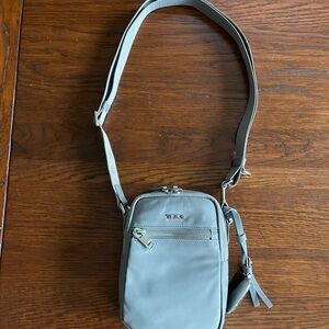 Gray Tumi crossbody bag
